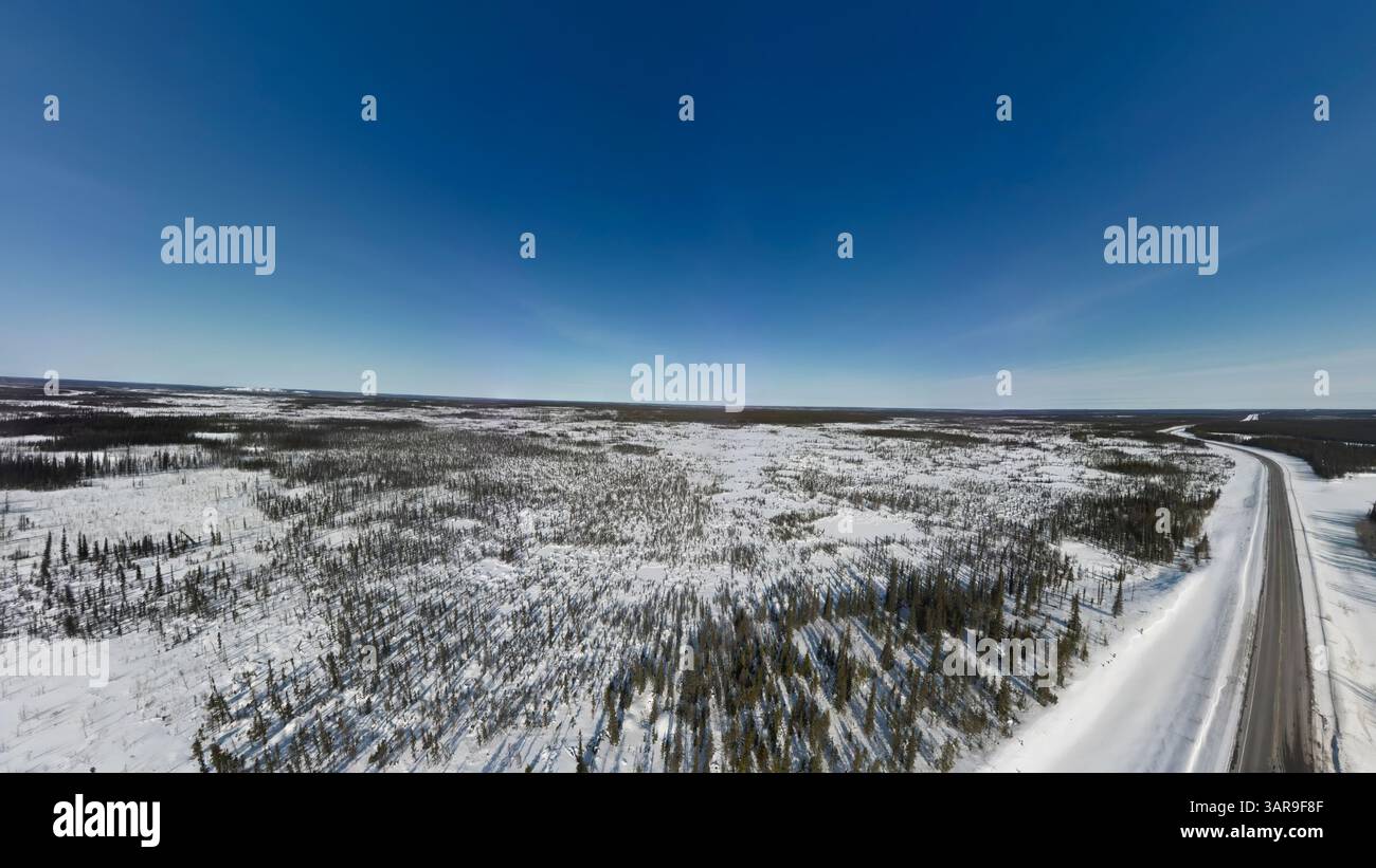 An aerial view of the MacKenzie Highway in winter near Behchoko in ...