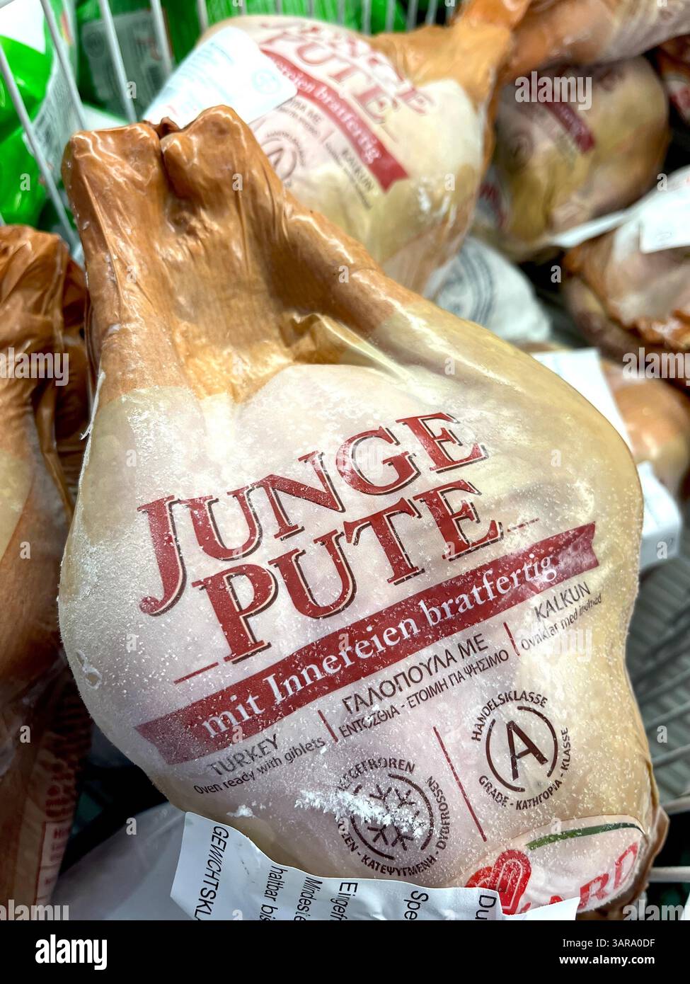 Whole young turkey displayed in a supermarket freezer, frozen poultry, product of Germany, German produce, consumerism, shopping, retail freezer - Smartphone Captured Stock Image