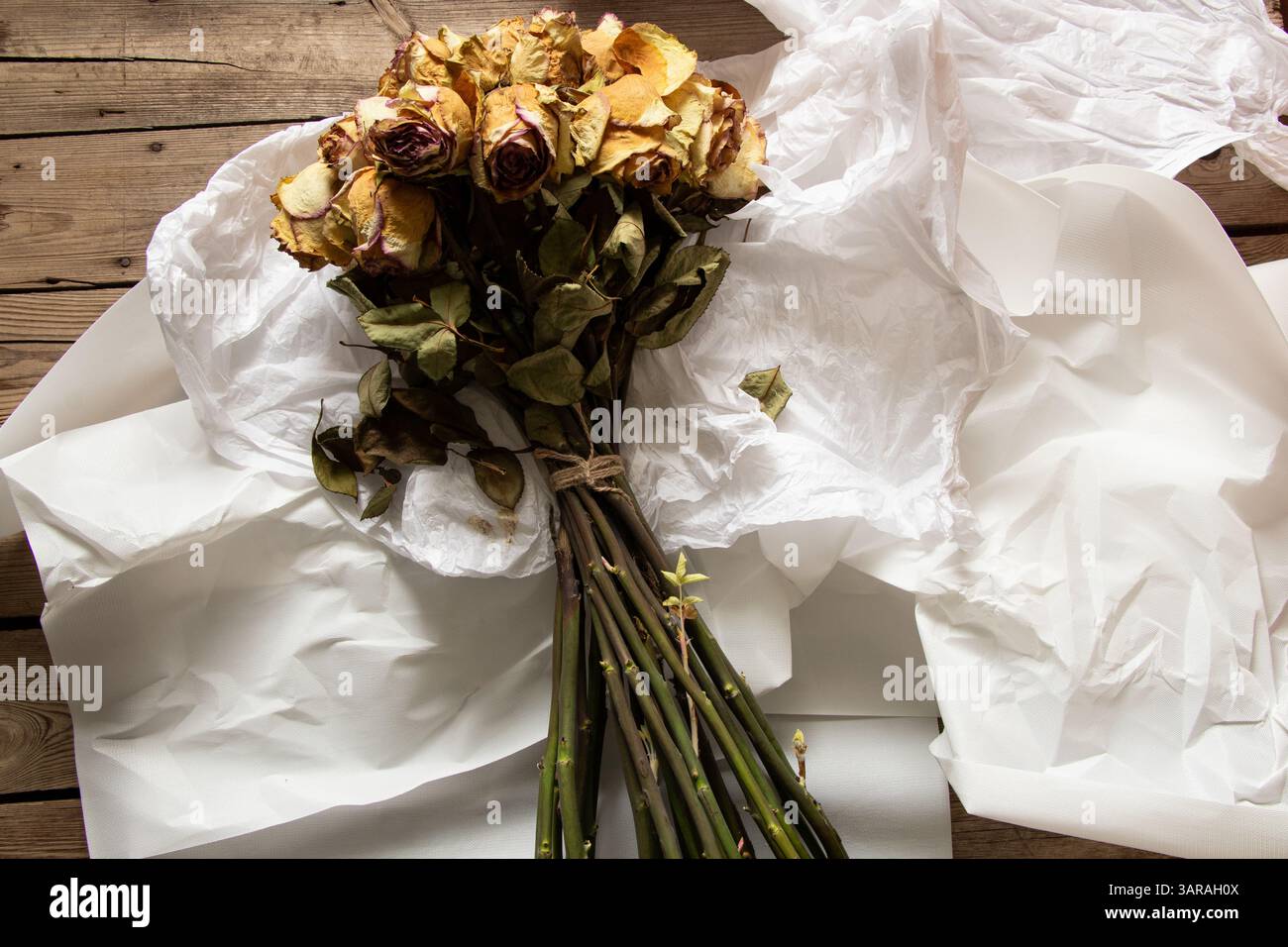 Large bouquet with roses and white wrapping on the table in ...