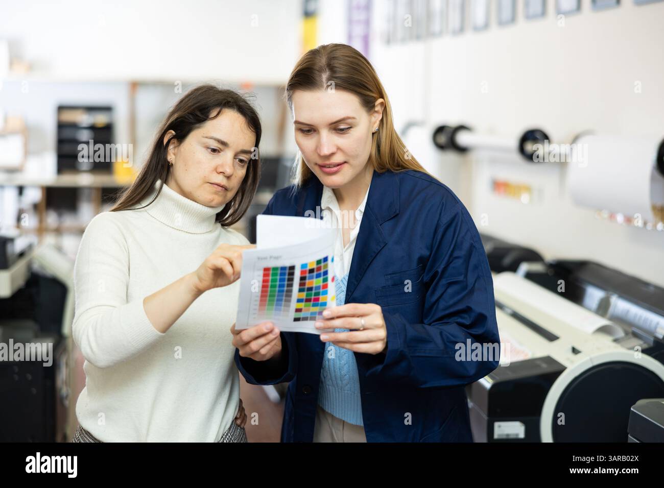 Women publishing facility workers having conversation about work Stock Photo