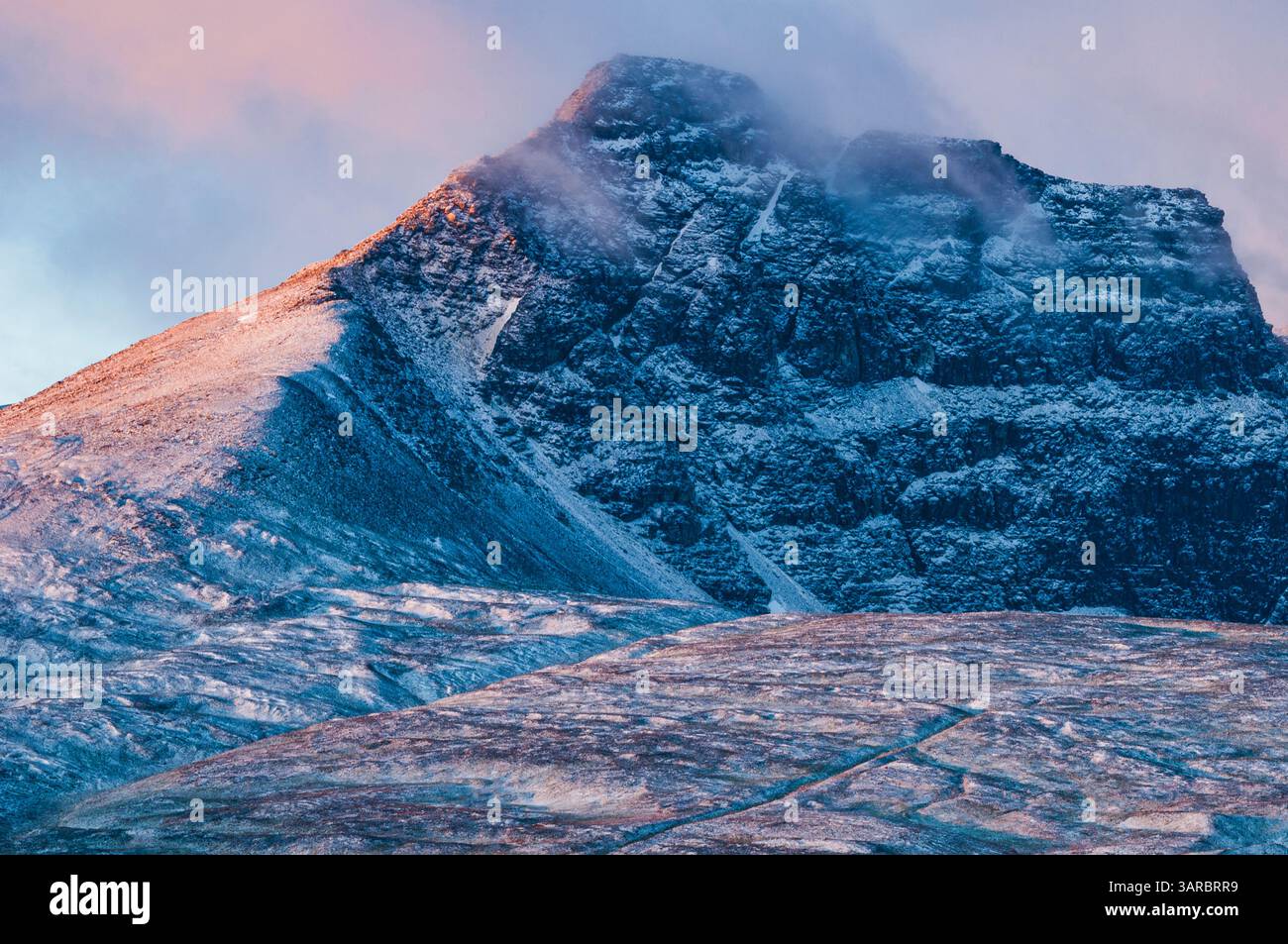 Mount Rondane Mountains of Rondane rise majestically against a vibrant sky, bathed in ...