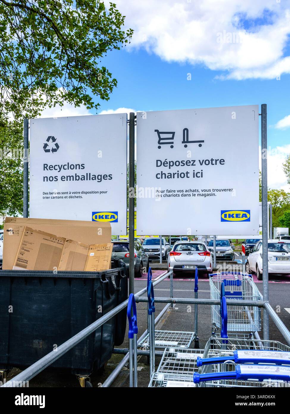 Notice boards in IKEA car park advising customers where to replace trolleys and put waste cardboard for recycling - Tours, Indre-et-Loire (37), France Stock Photo