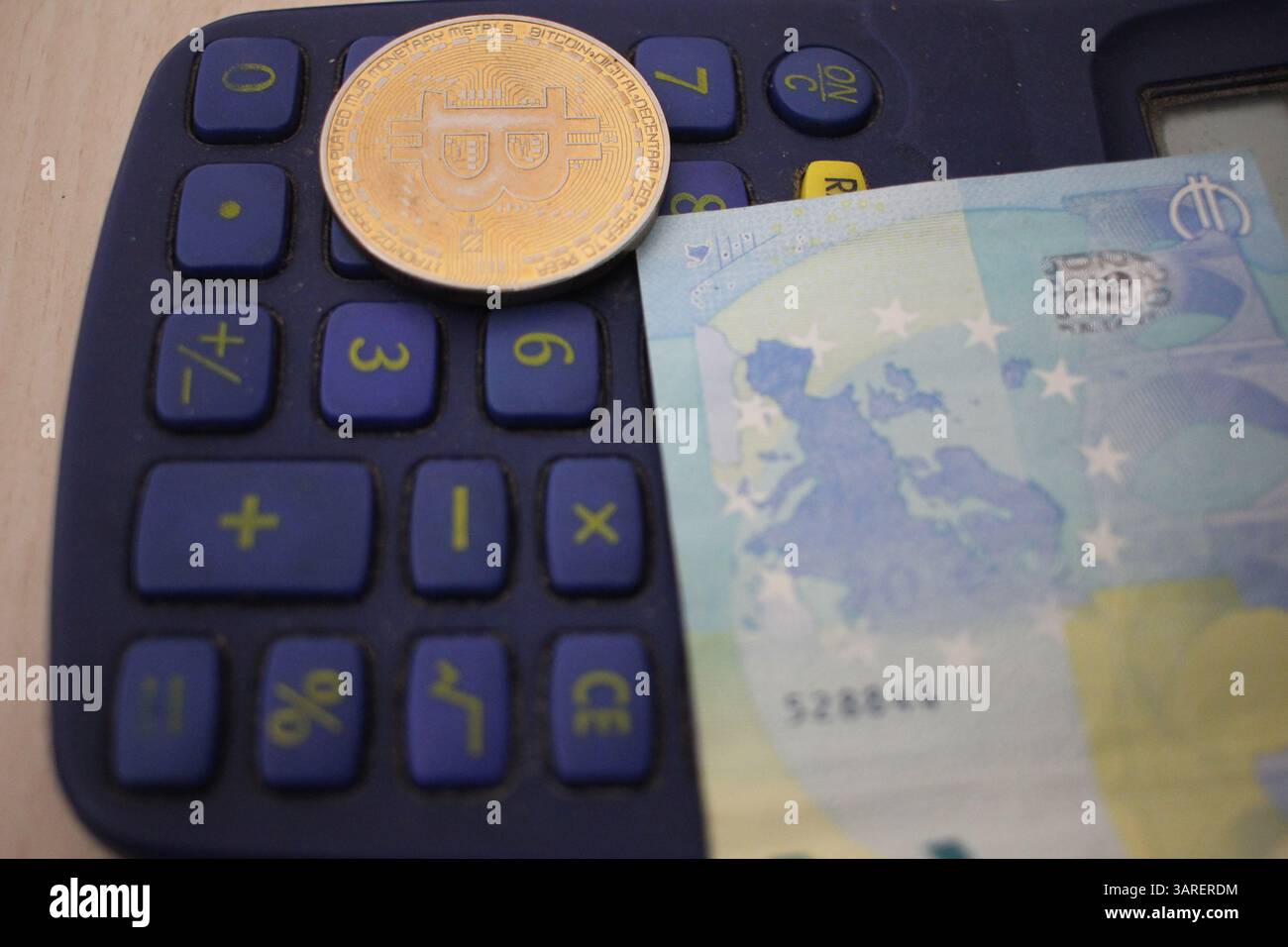 bitcoin and euro on top of a calculator. Concept , analyzing which  investment is better Stock Photo - Alamy
