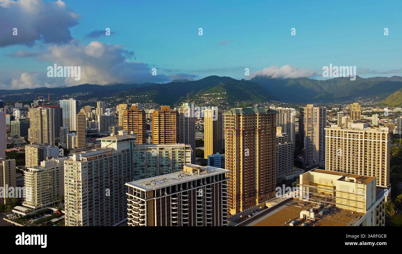 Aerial view of Honolulu high-rise buildings and lush mountains Stock ...