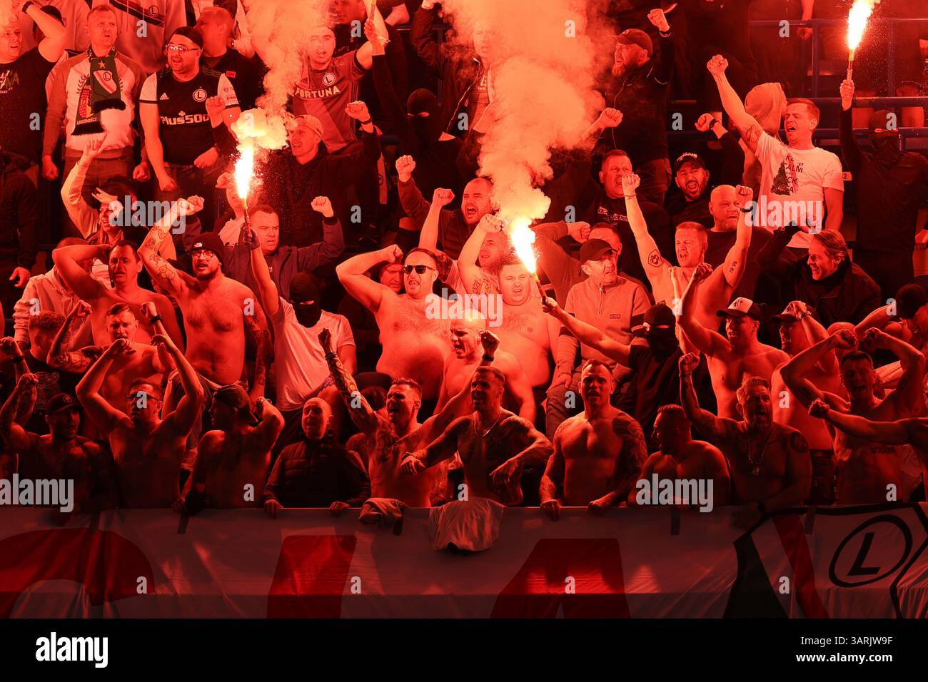 London, UK. 17th Apr, 2025. London, England, April 17th 2025: Legia Warszawa fans light up flares during the UEFA Conference League match between Chelsea and Legia Warszawa at Stamford Bridge in London, England (Alexander Canillas/SPP) Credit: SPP Sport Press Photo. /Alamy Live News Stock Photo