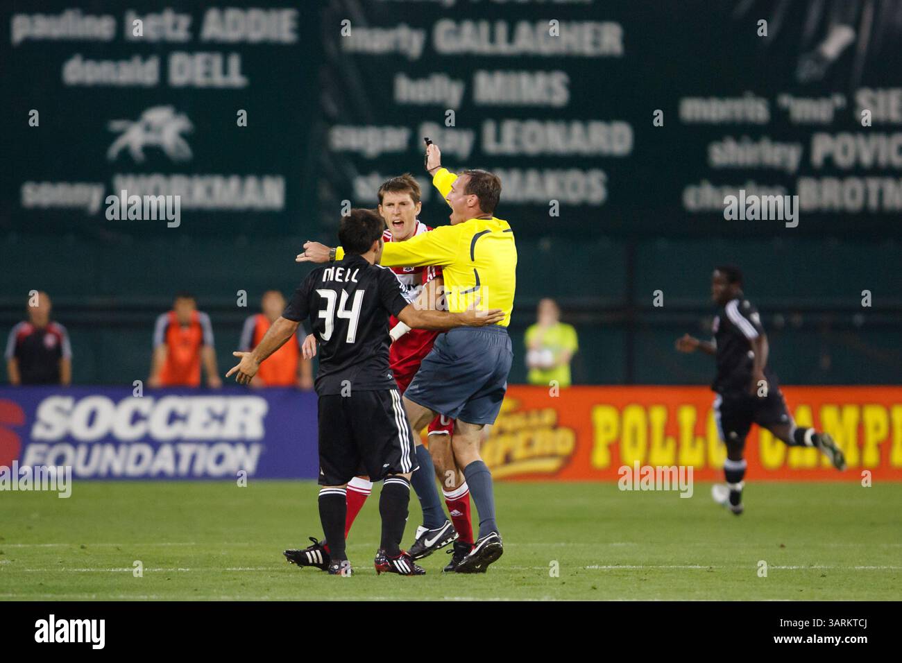 Referee Terry Vaughn separates DC United and Chicago Fire players during a Major League Soccer match on May 8, 2008 at RFK Stadium in Washington, DC. Editorial use only. Commercial use prohibited. Stock Photo