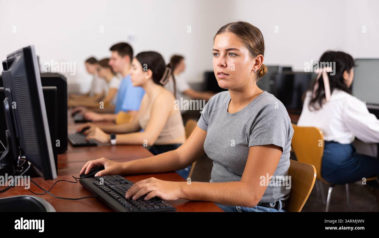 Woman learning to use software in computer class Stock Photo
