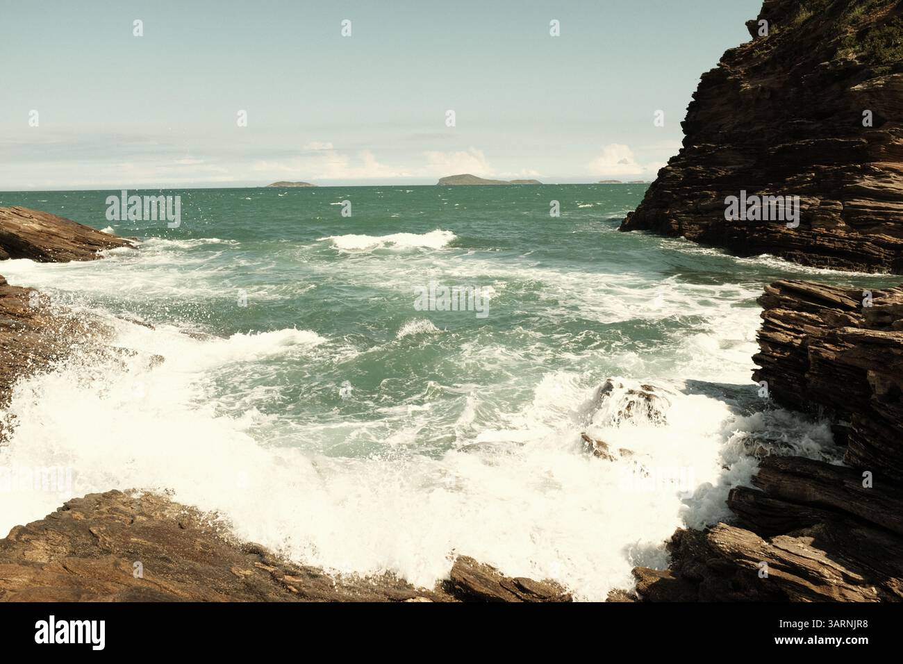Waves hitting rocks in Buzios, Brazil Stock Photo