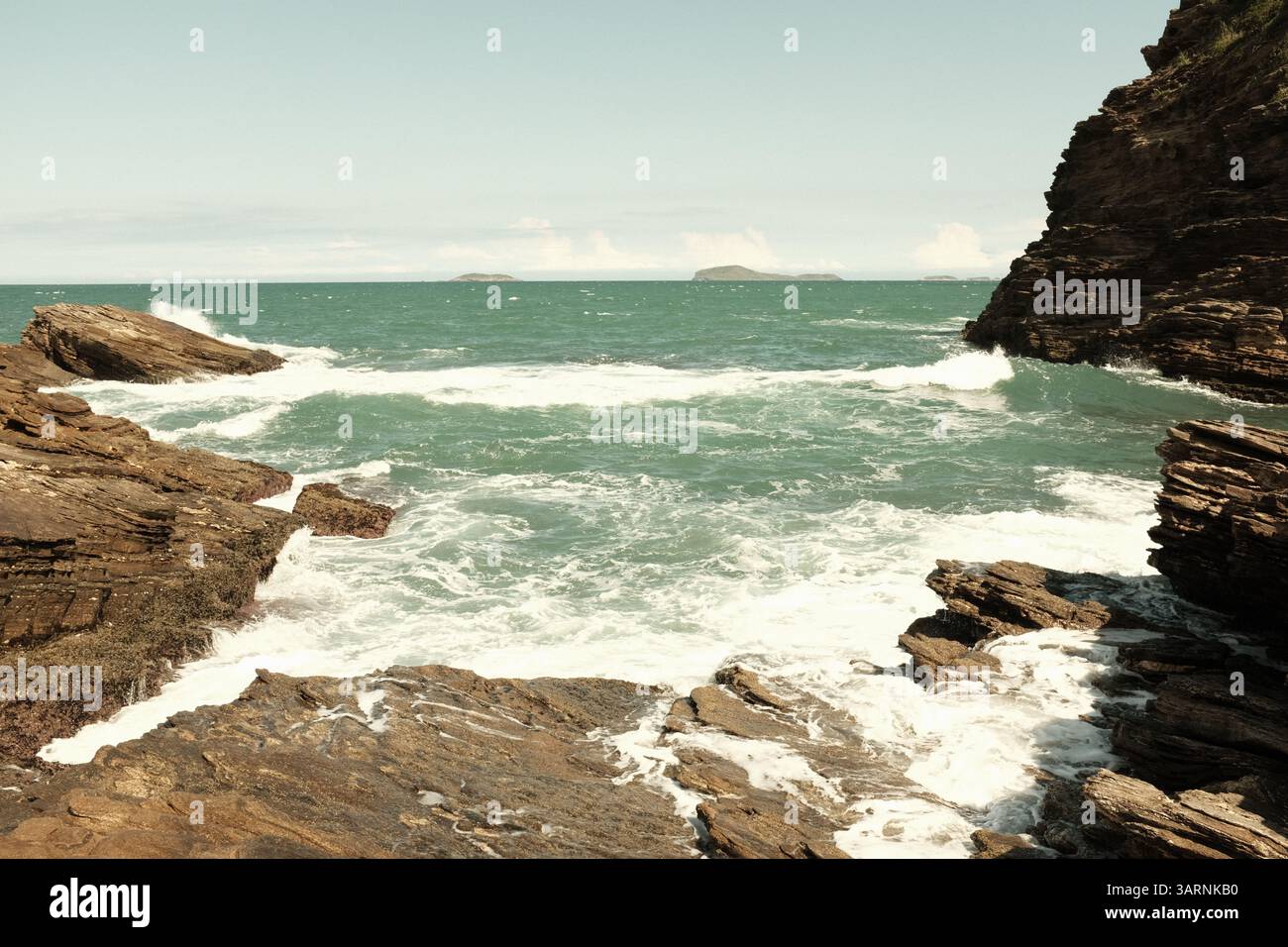 Waves hitting rocks in Buzios, Brazil Stock Photo
