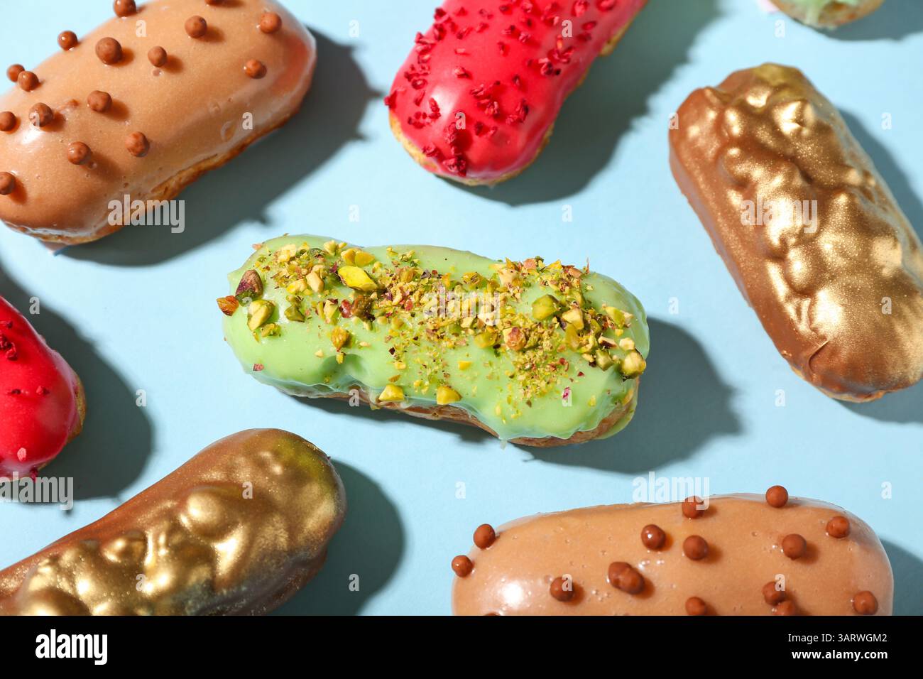Composition with various glazed eclairs on color background Stock Photo