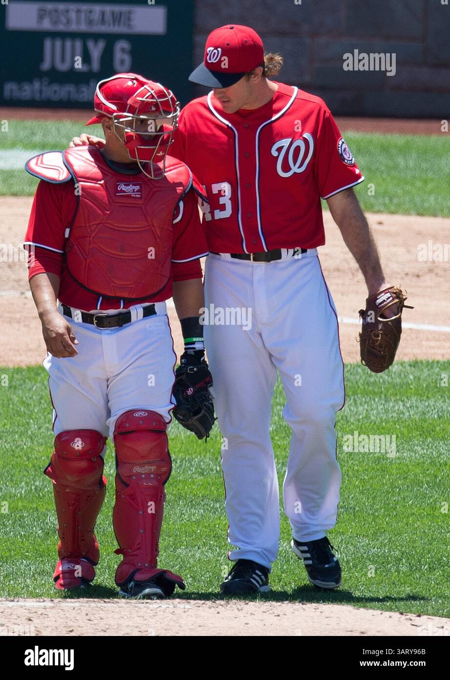 Washington Nationals catcher Jhonatan Solano (23) stands in front of the  Columbian flag before a baseball game against the Miami Marlins at  Nationals Park Wednesday, Aug. 28, 2013, in Washington. (AP Photo/Alex