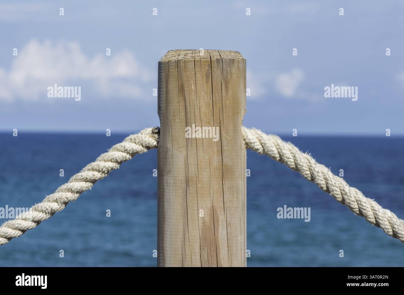 Fence post - cord - protection on the coast Stock Photo