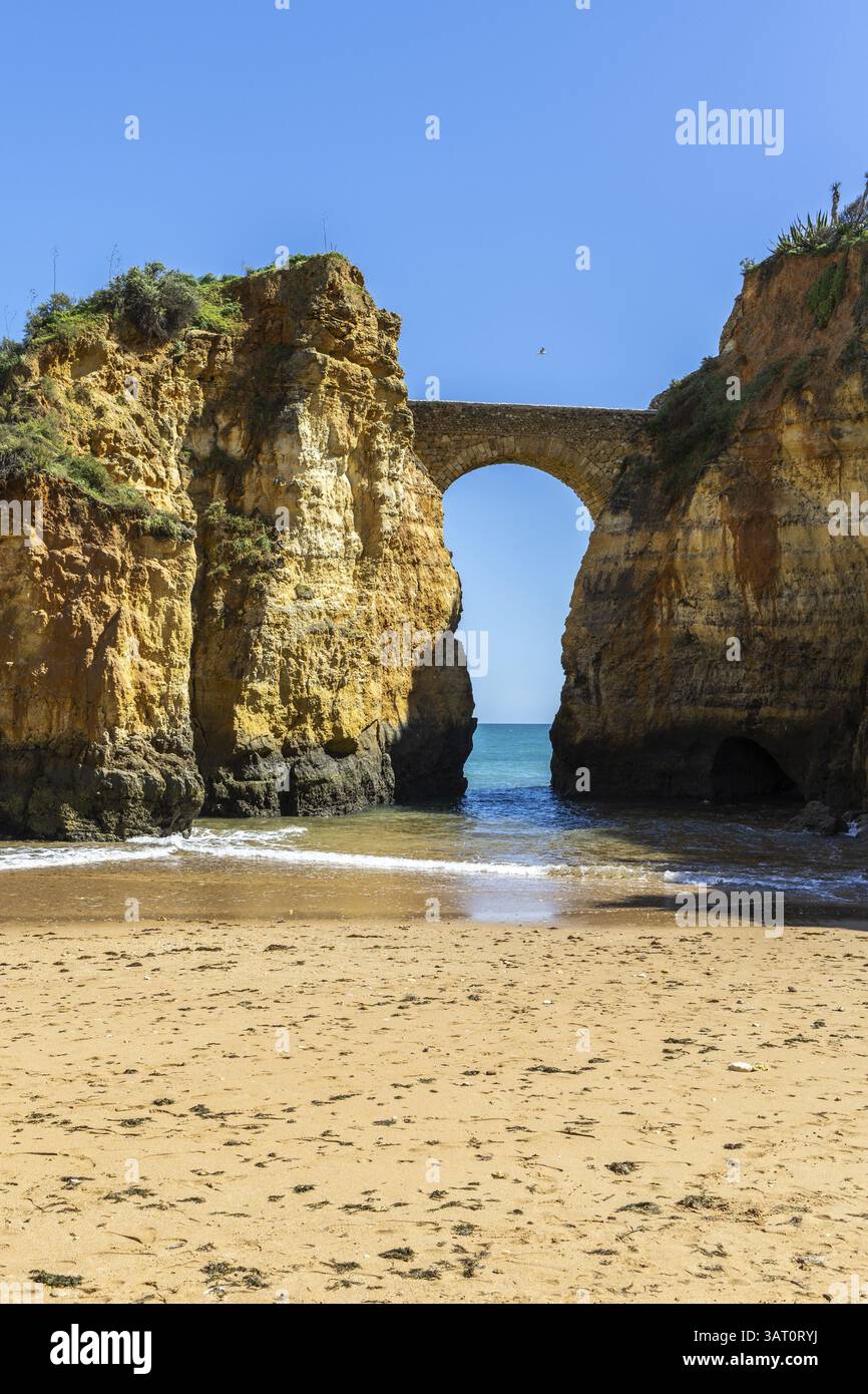 Yellow rocks and cliffs on a sandy beach. A bay by the sea, over which ...