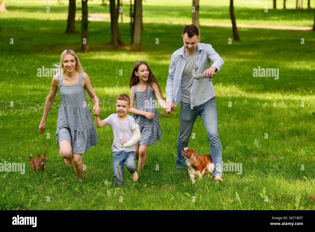 Happy family running barefoot hi-res stock photography and images - Alamy