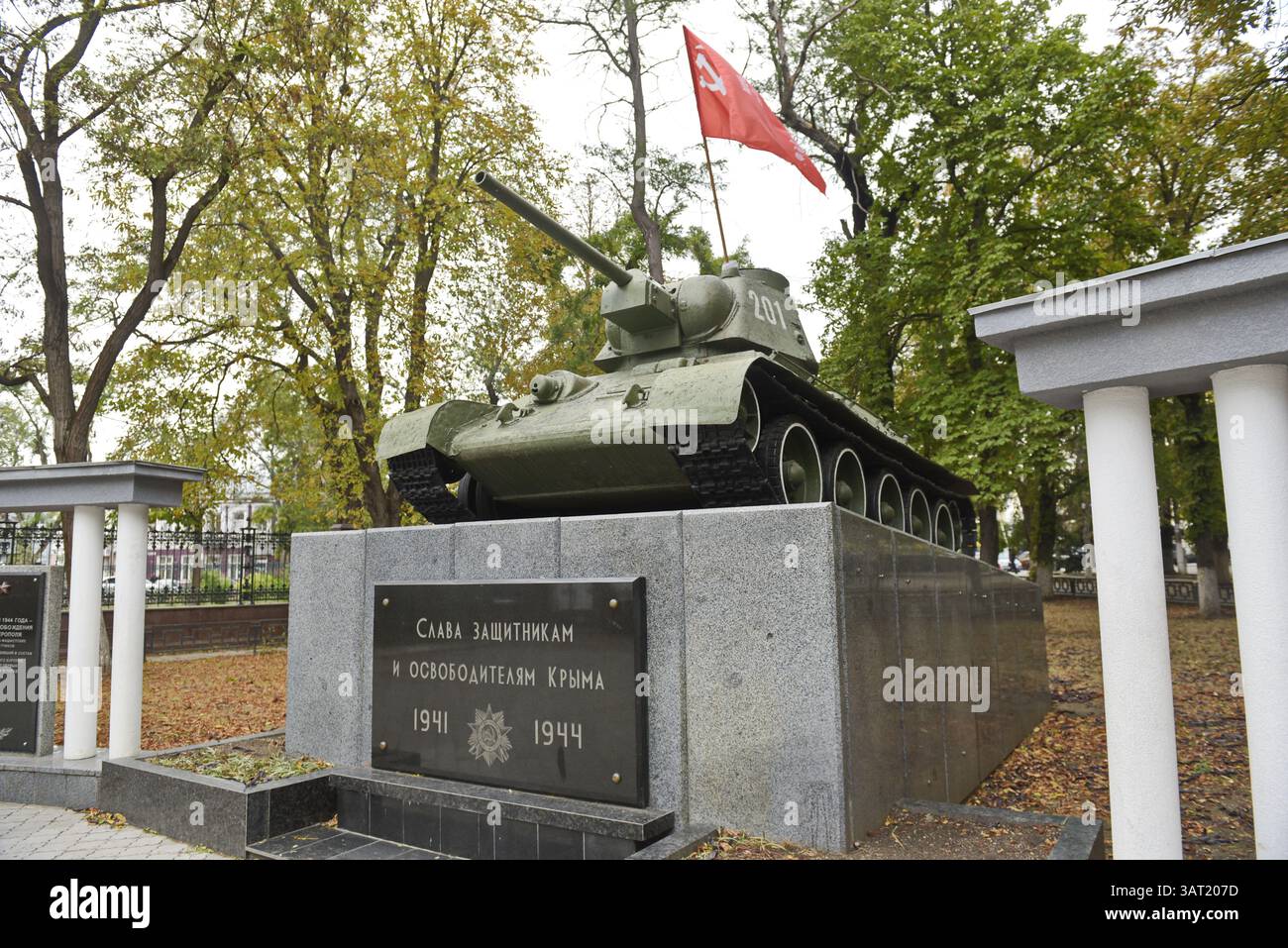Soviet monument with a tank and a flag with the inscription: Glory to ...