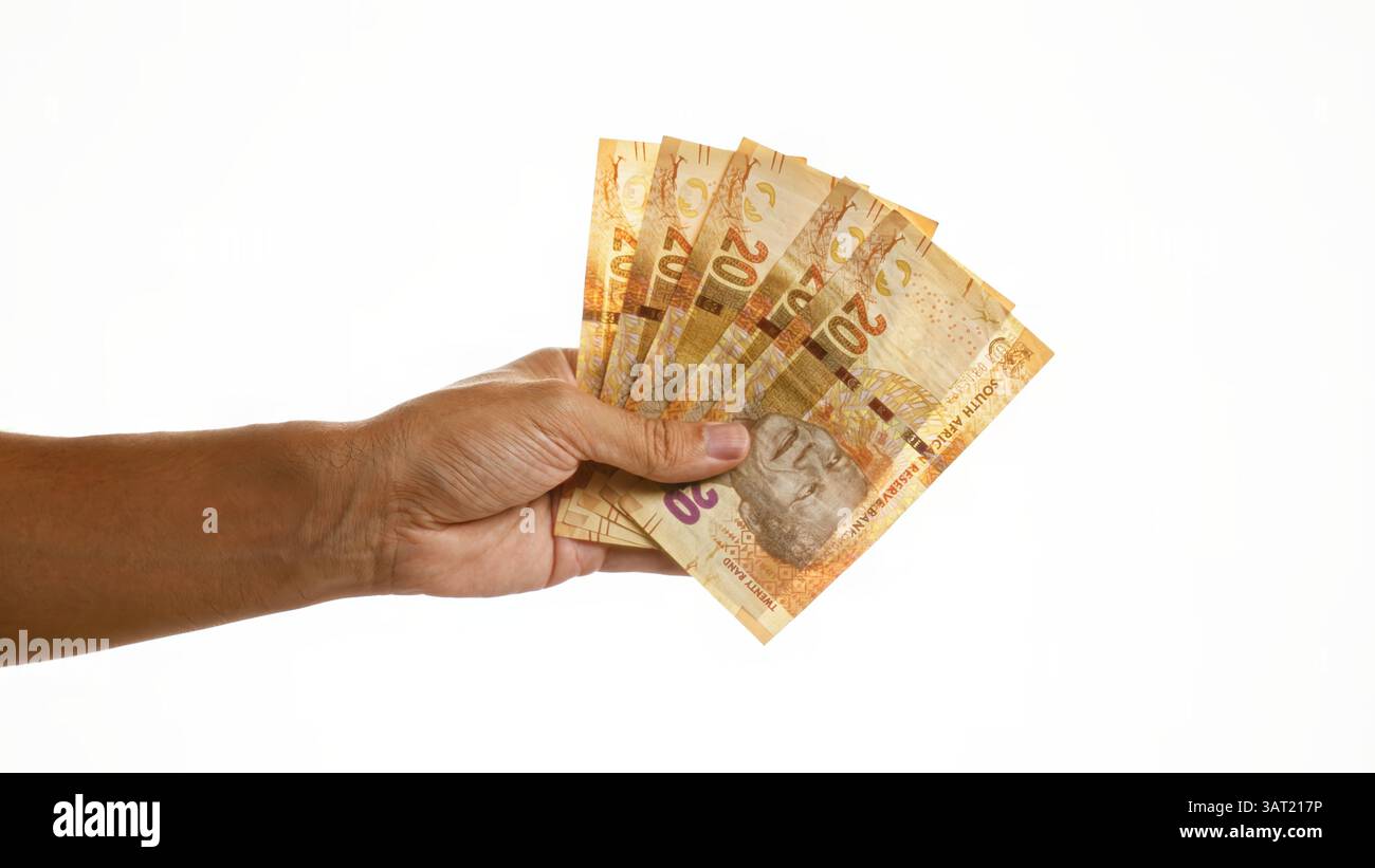 Hand holding south african rands against isolated white background with ...