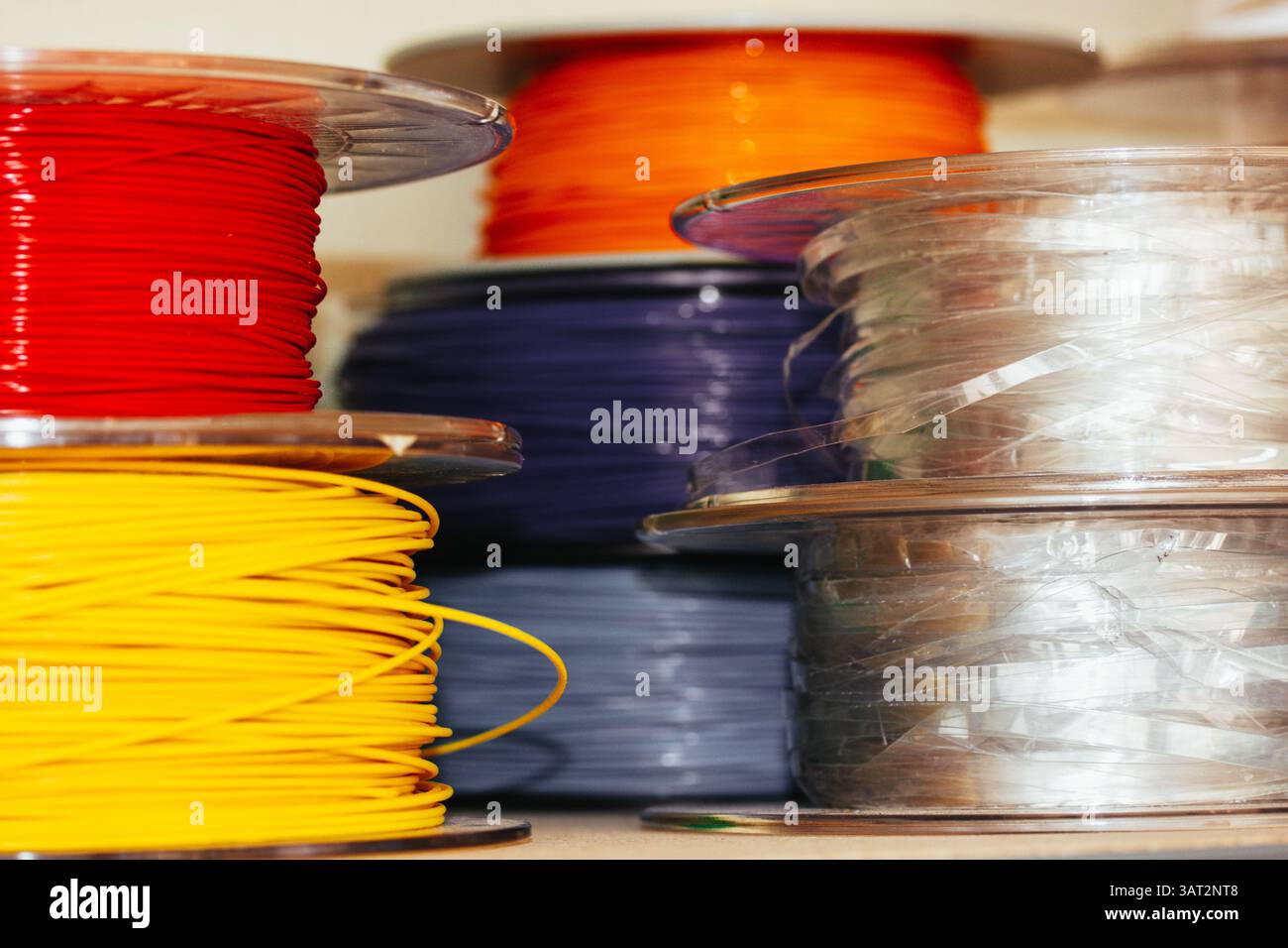 Spools Photo Developing Colorful 3d printing filament spools are stacked, showing vibrant reds ...