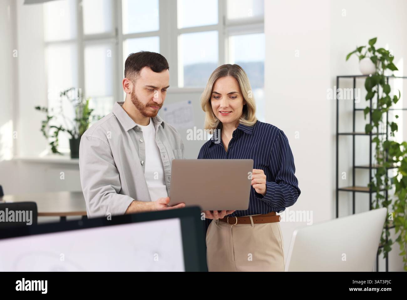 Engineers working together with laptop in office Stock Photo