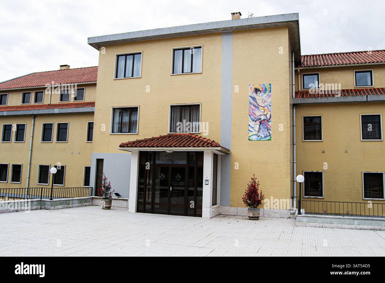Fatima Building Fatima, Portugal - April 15, 2025: Yellow tinted building with detailed ...