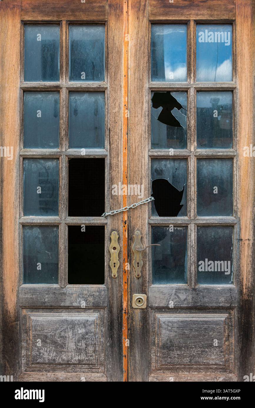 Old wooden door with broken windows Stock Photo