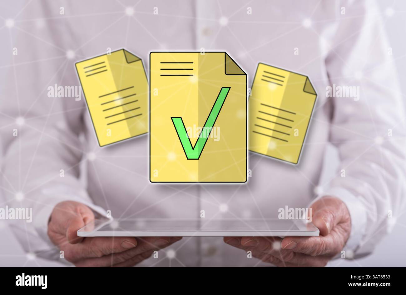 Document validation concept above a tablet held by a man in background Stock Photo