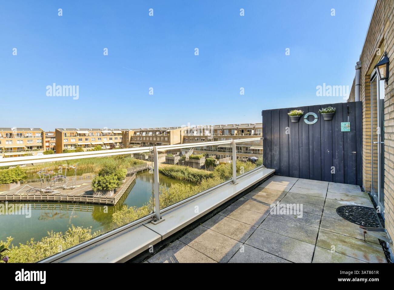 View of A modern residential balcony showcases a beautiful view of green ...