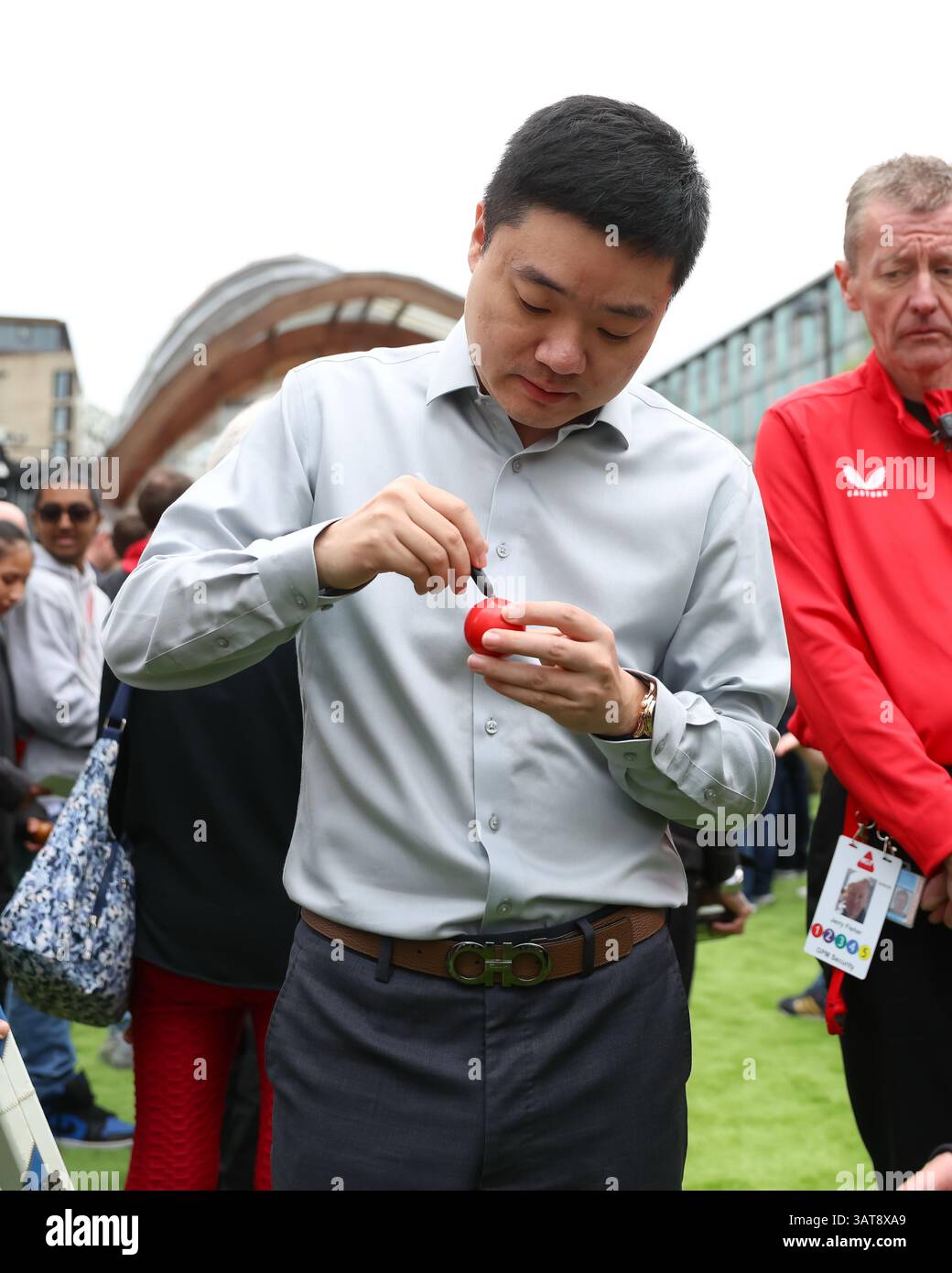 Ding Junhui signs a snooker ball during the 2025 Halo World Snooker ...