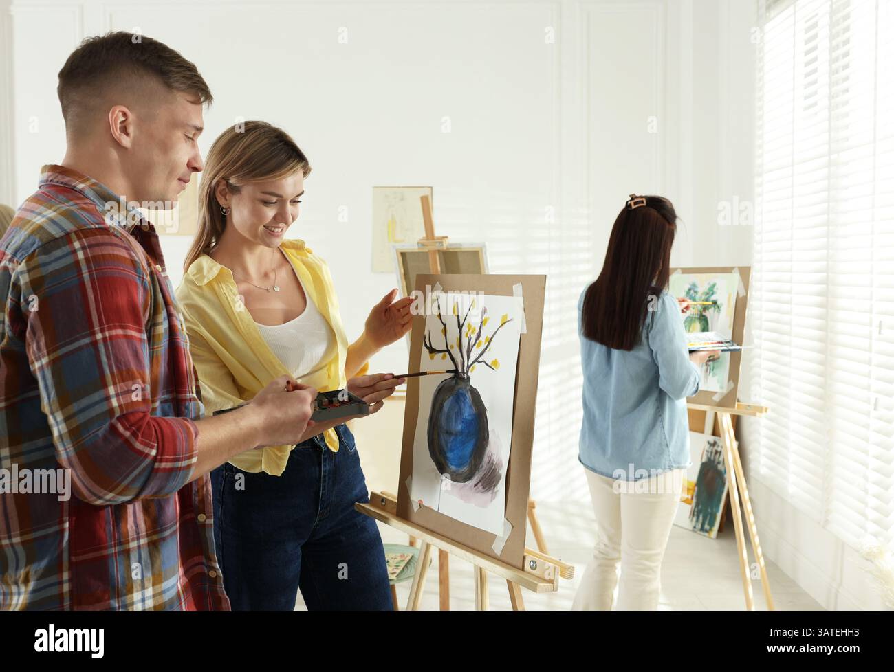 Artist and her students having painting class in studio Stock Photo - Alamy