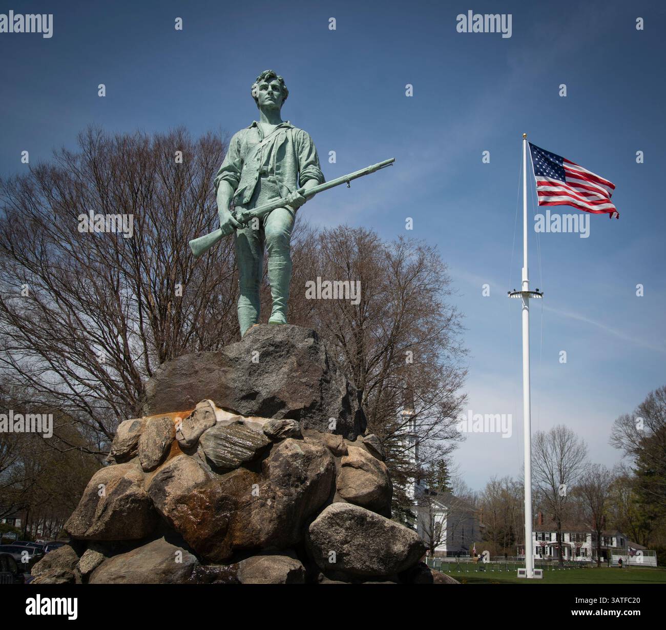 Lexington, Massachusetts, USA. 18 April 2025. Day before Patriots’ Day on the 250th anniversary of the start of the American Revolution on 19 April 1775.  Statue of Captain John Parker on the Lexington Green on Massachusetts Avenue in Lexington.  Early in the morning of 19 April hundreds of mostly local men and women in period dress stage a reenactment on the Lexington Green of the first battle between British Soldiers and local Militia men that was the start of the American Revolutionary War. Credit: Chuck Nacke / Alamy Live News Stock Photo
