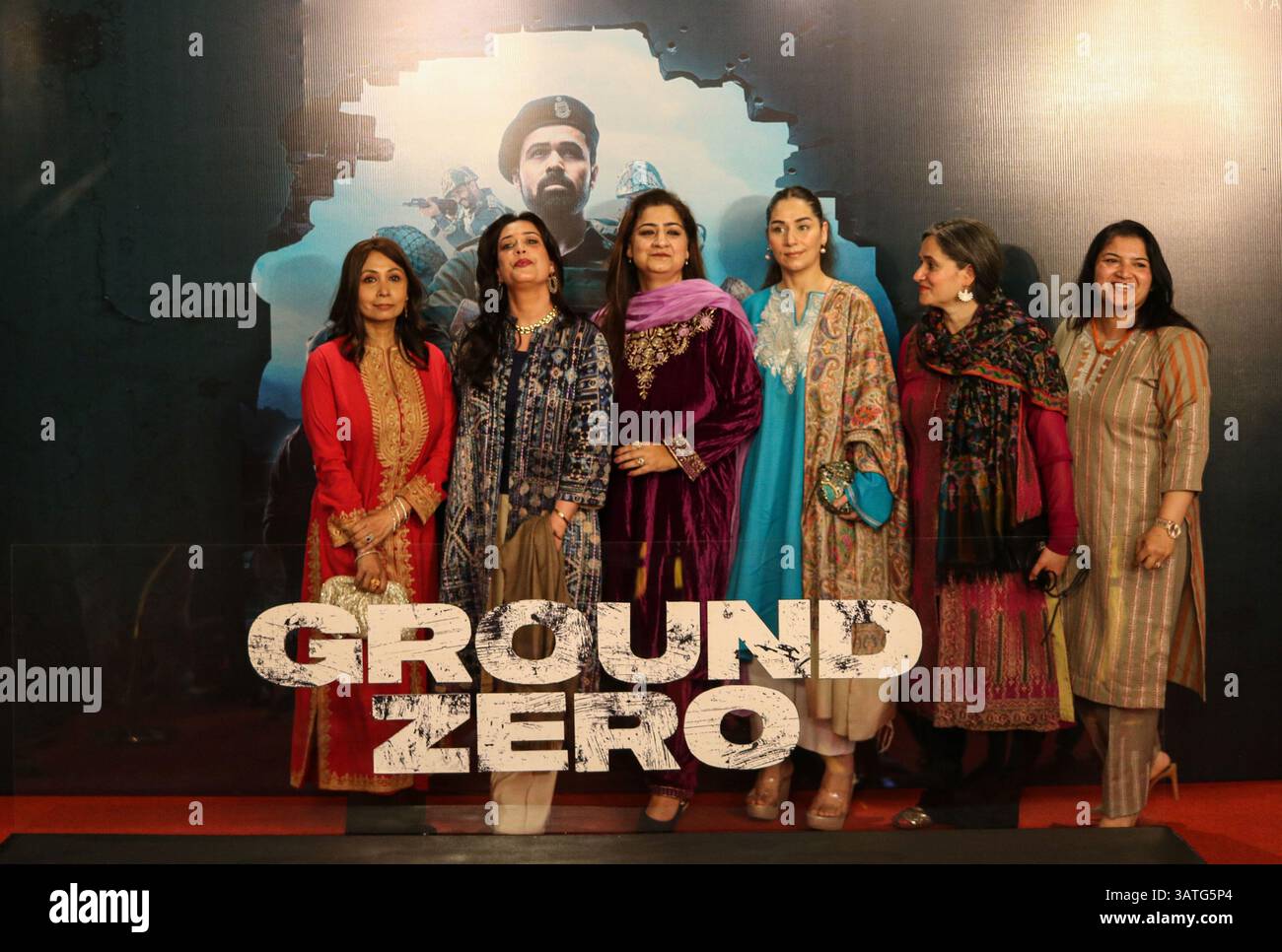 Fans take pictures next to a billboard of the movie ''Ground Zero ...