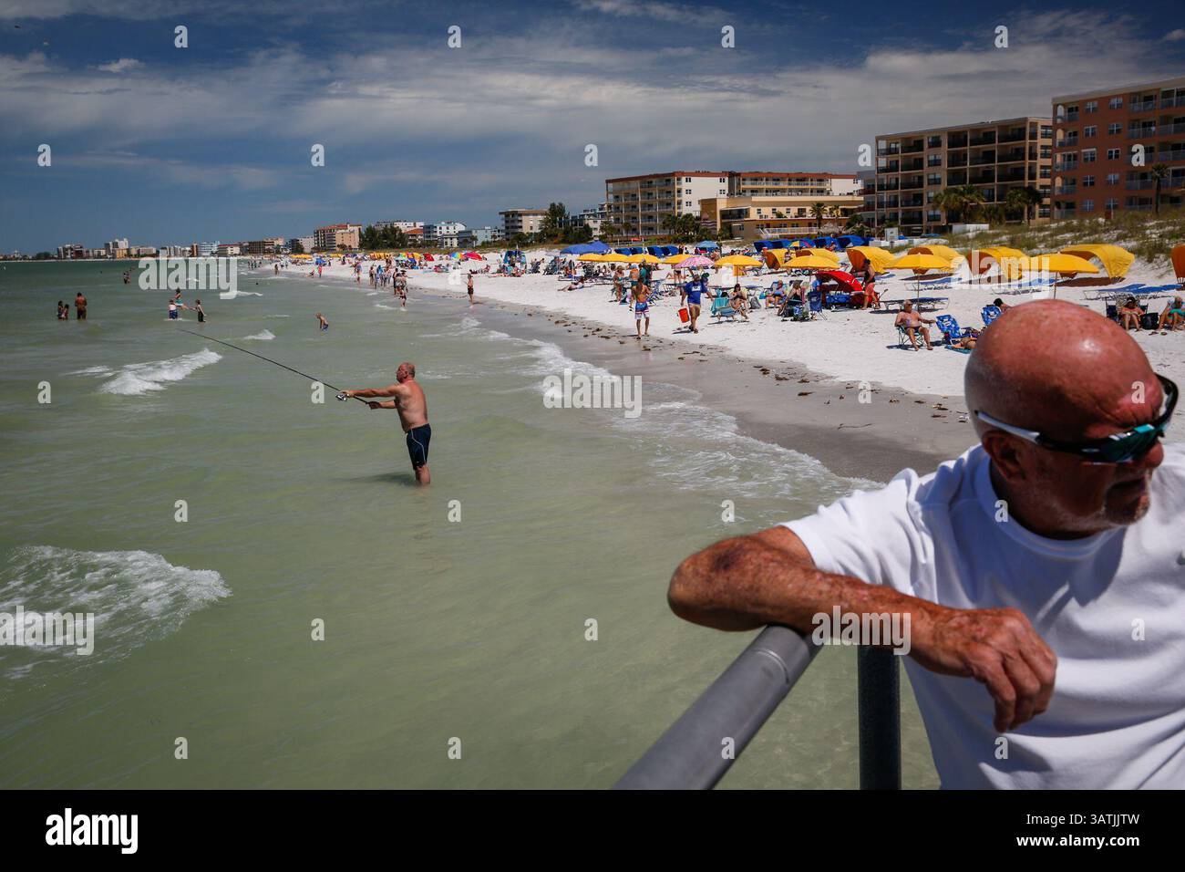 April 10, 2016 - St. Petersburg, Florida, U.S. - LOREN ELLIOTT   |   Times.G.C. Jans (center) of Amsterdam, Netherlands, fishes just north of John's Pass in St. Petersburg, Fla., despite a toxic algal bloom Sunday, April 10, 2016. The algal bloom, often referred to as a ''red tide'', produces toxins that can kill fish, mammals, birds, and directly or indirectly cause illness to humans. (Credit Image: © Loren Elliott/Tampa Bay Times via ZUMA Wire) Stock Photo