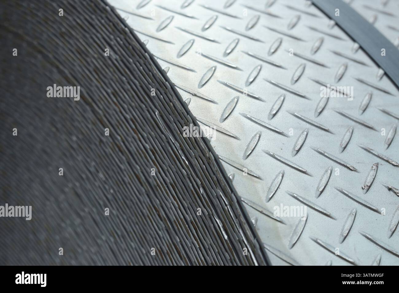 close up a roll of steel coil. The pattern texture of the metal plate ...