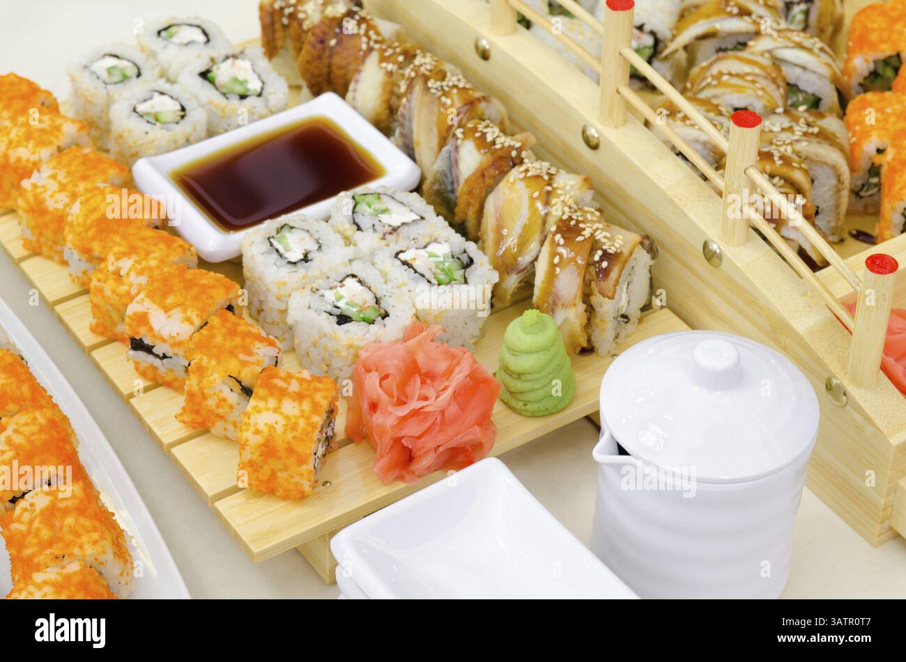 Many sushi rolls served with wasabi, ginger and soy sauce Stock Photo