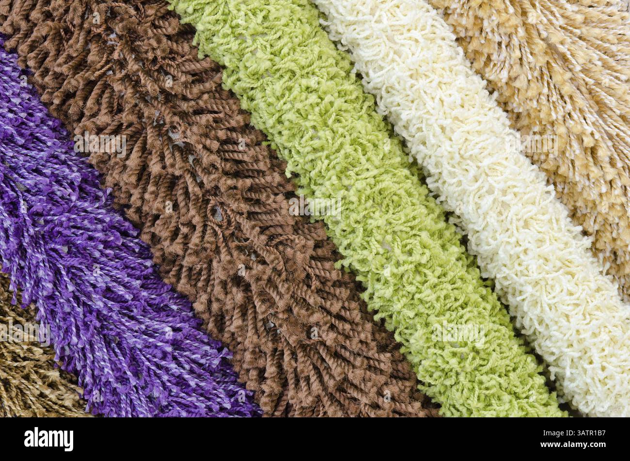 Different colourful artificial shaggy carpet samples, closeup Stock Photo