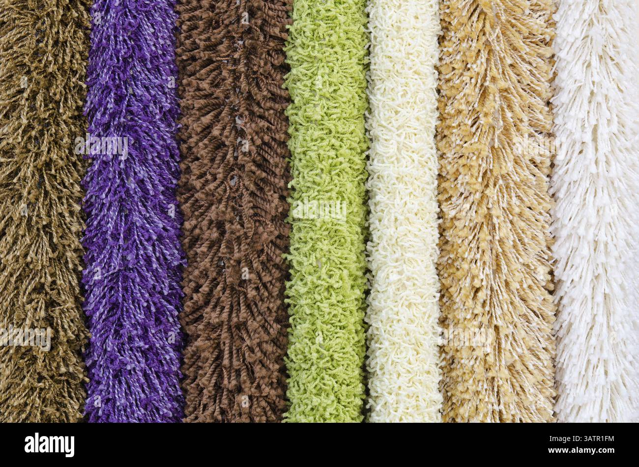Different colourful artificial shaggy carpet samples, closeup Stock Photo