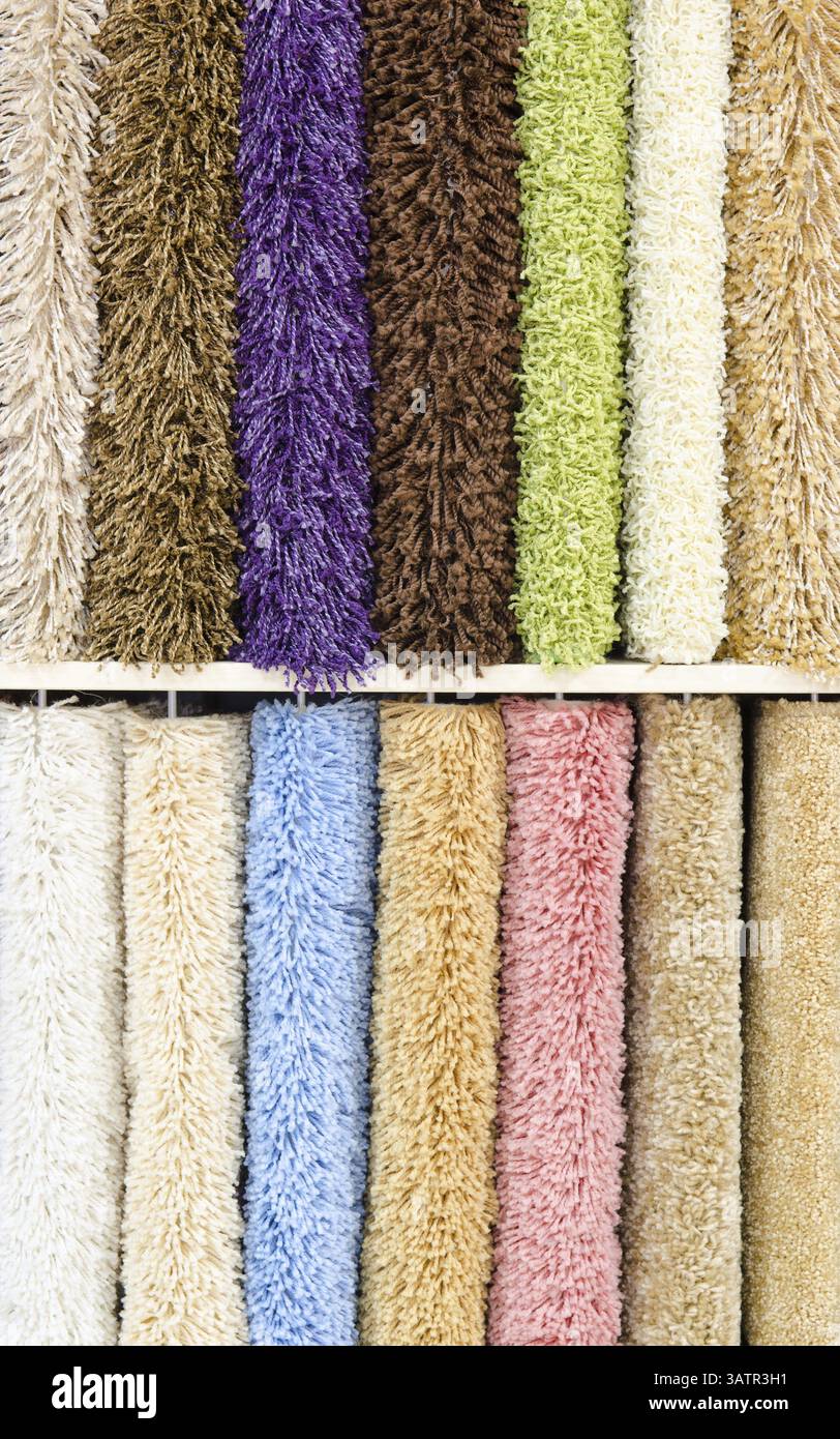 Different colourful artificial shaggy carpet samples, closeup Stock Photo