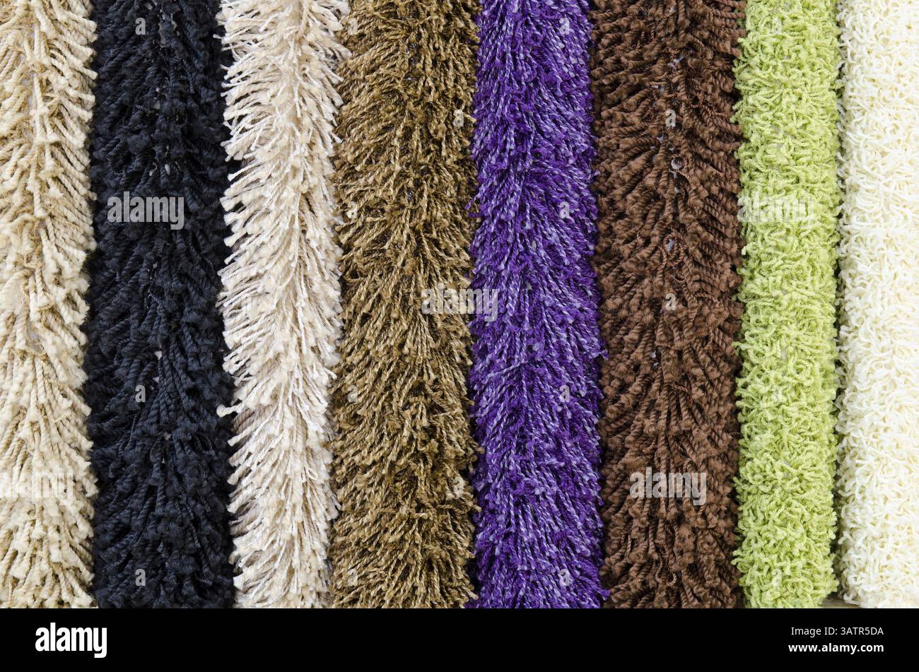 Different colourful artificial shaggy carpet samples, closeup Stock Photo