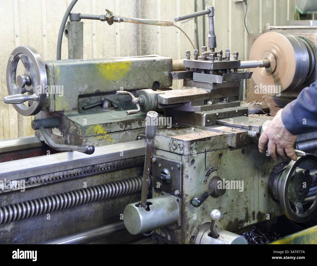 An operator works at a metal working machine Stock Photo