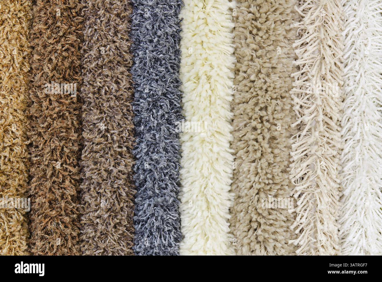 Different colourful artificial shaggy carpet samples, closeup Stock Photo