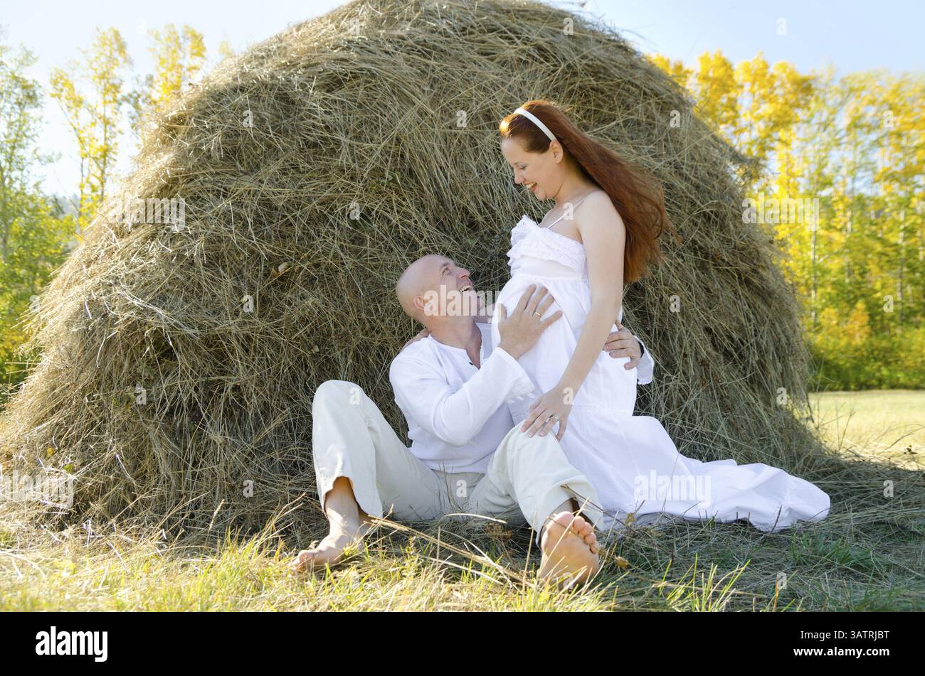 Happy married couple - husband hugs his pregnant wife Stock Photo - Alamy