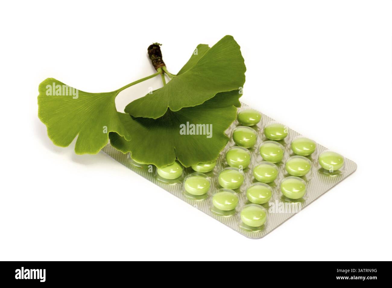 Green tablets with gingko leaves - cropped on a white background Stock Photo