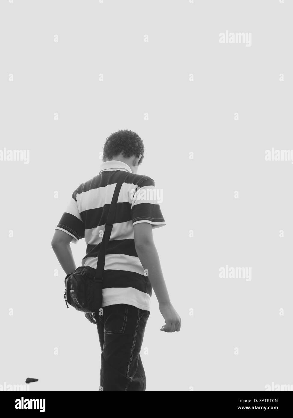 Walking Alone A Striking Monochrome Visual Perspective on Solitude and Lifes Journey Stock Photo