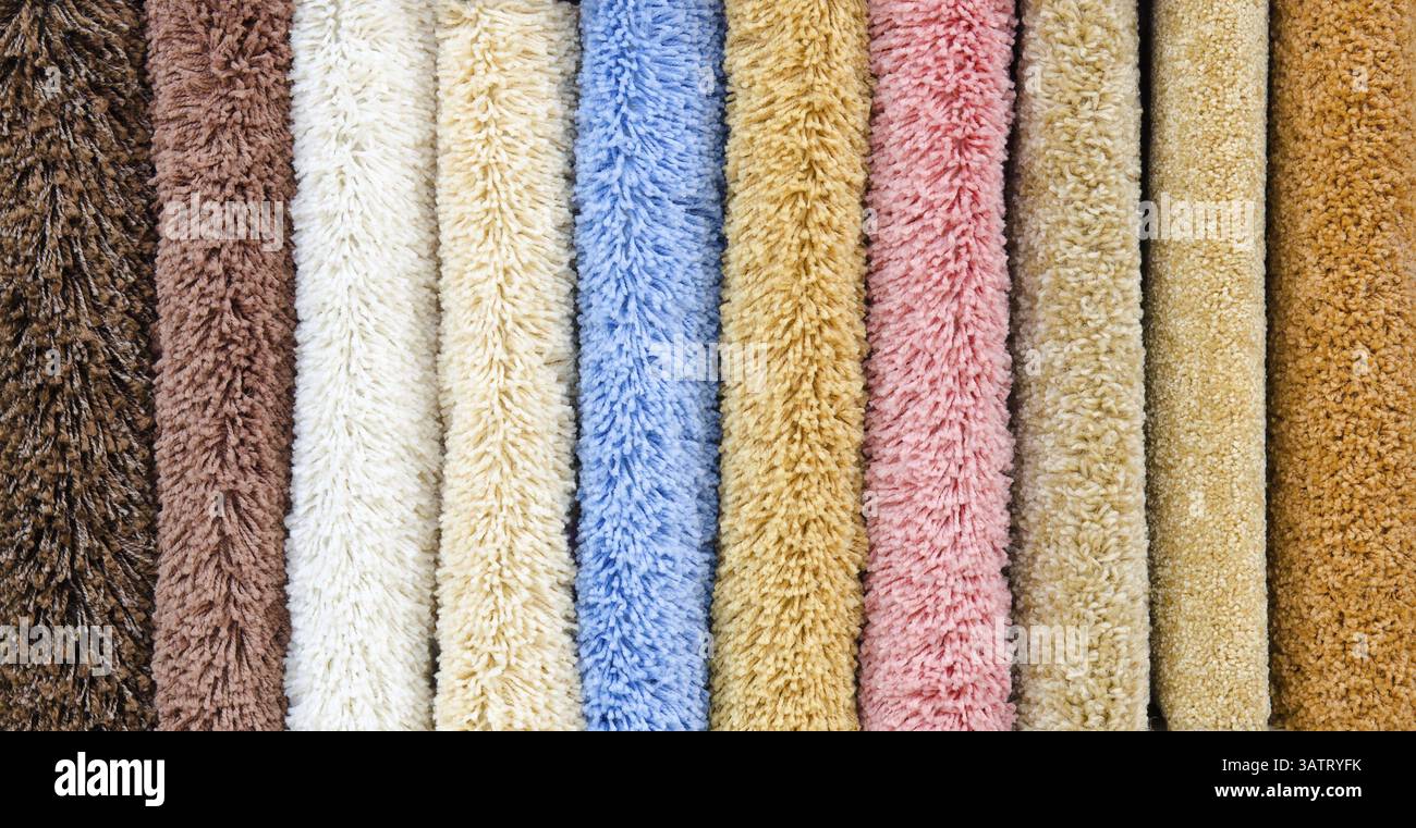 Different colourful artificial shaggy carpet samples, closeup Stock Photo