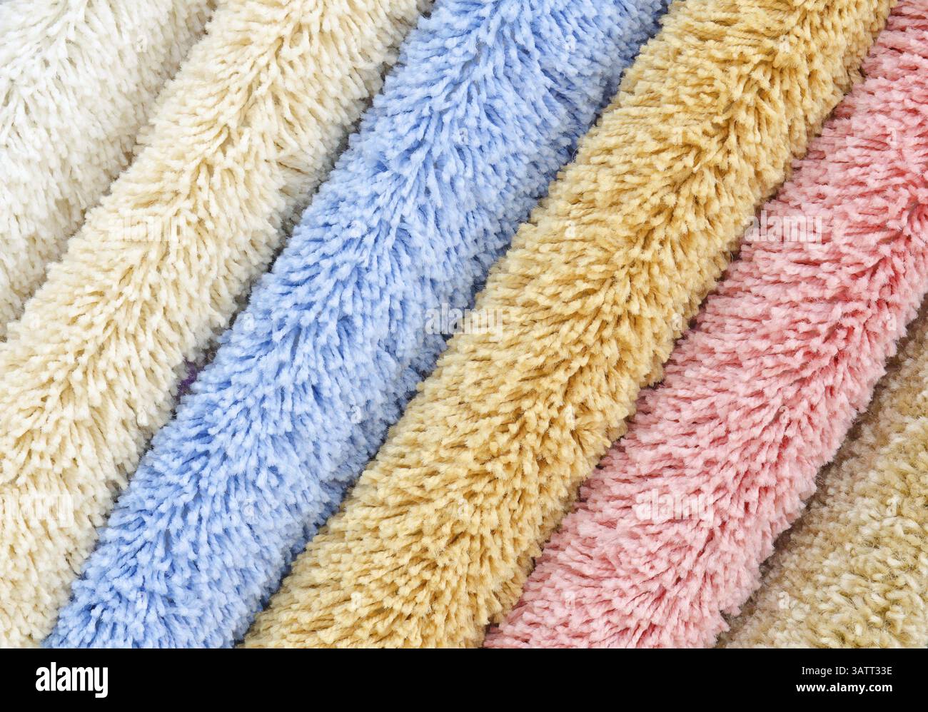 Different colourful artificial shaggy carpet samples, closeup Stock Photo