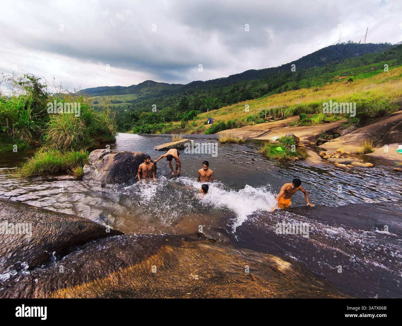 Young People Swimming and Playing in a Natural Rock Pool in the Hills – Outdoor Adventure and Summer Fun - Smartphone Captured Stock Image