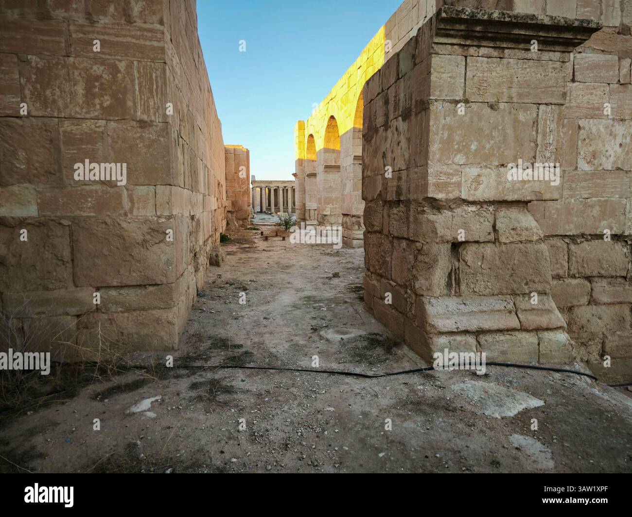 Ancient stone ruins with arches and columns under a clear blue sky ...