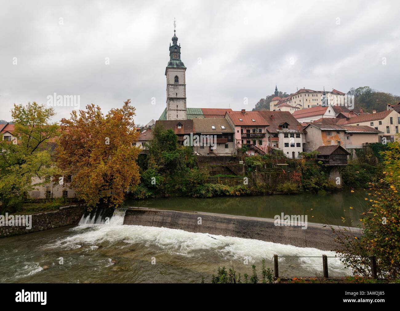 Old town of skofja loka and sora river with colorful houses against cloudy sky. Slovenia Europe Stock Photo
