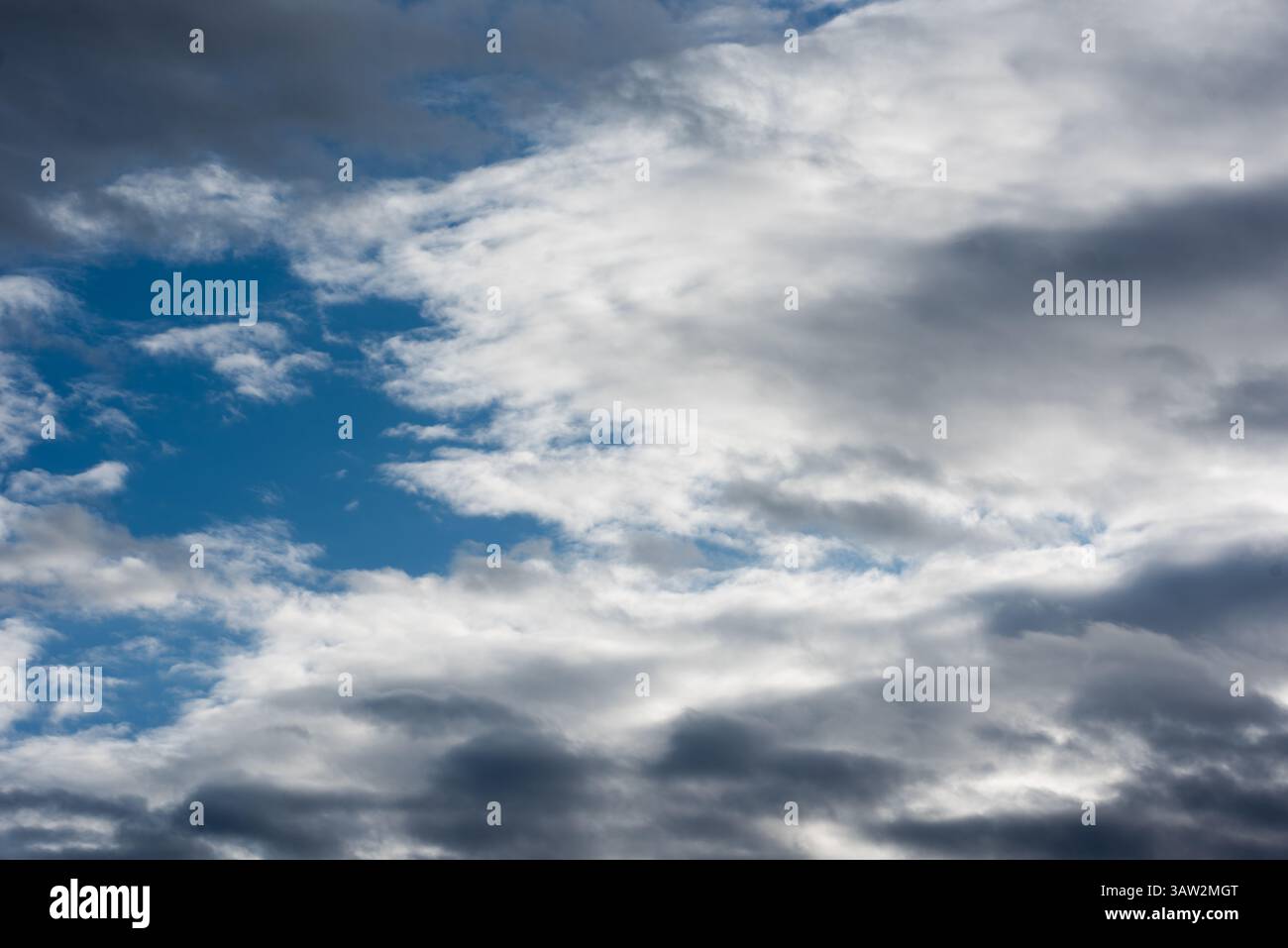 Scattered cloud clusters in a blue sky Stock Photo
