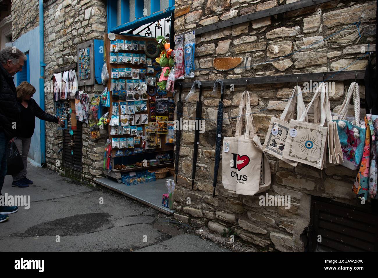 Colorful handmade souvenirs outside the traditional shop with the stoned wall in a charming stone alley. Lefkara village Cyprus Stock Photo