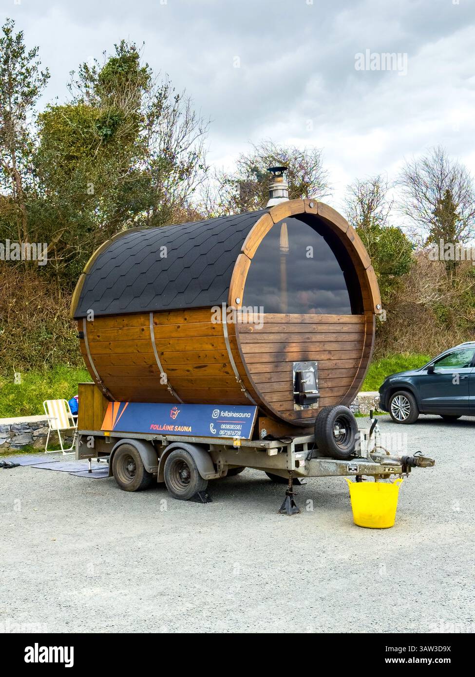 A mobile sauna for the swimmers at Annaghdown pier on Lough Corrib, county Galway, Ireland - Smartphone Captured Stock Image